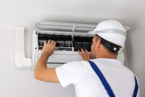 man working on an air conditioning unit