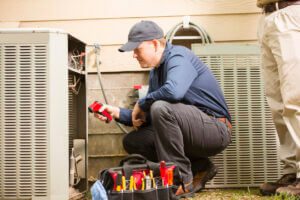 Hurricane preparation - an HVAC technician checking the system before a hurricane hits.